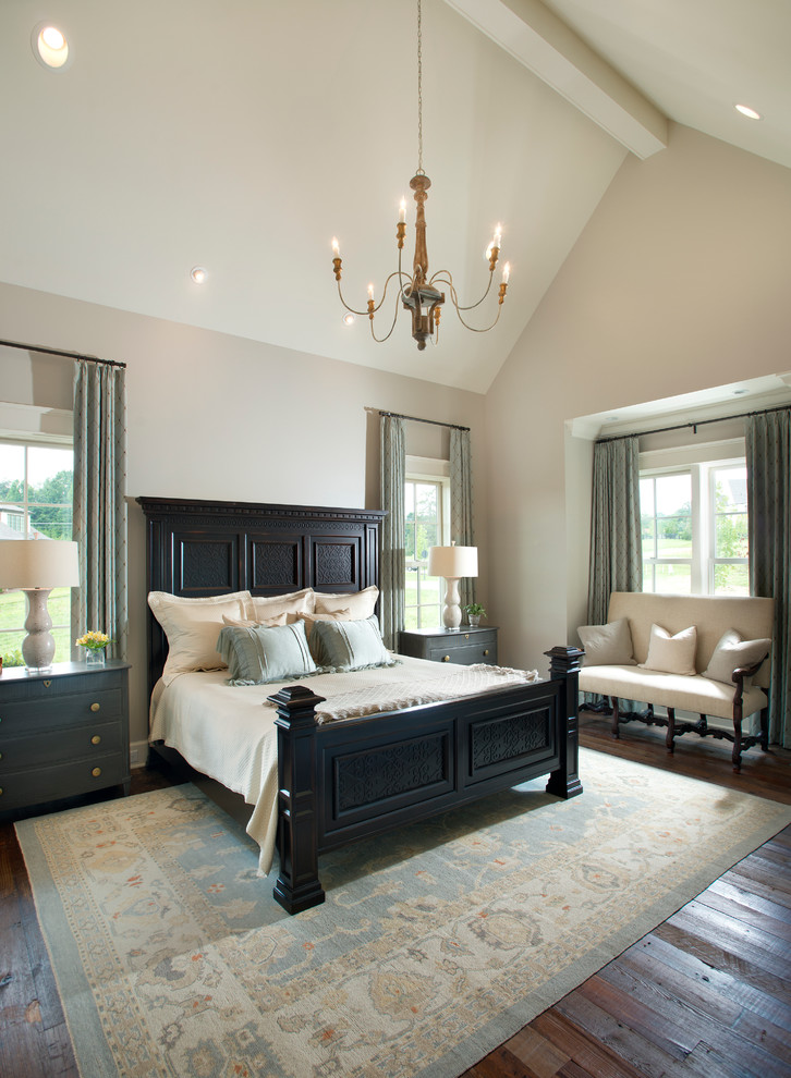 Photo of a country master bedroom in Nashville with beige walls and medium hardwood floors.
