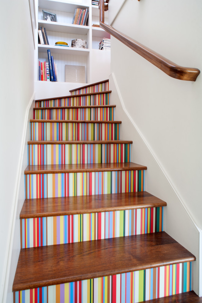 Inspiration for an eclectic wood l-shaped staircase in Los Angeles with painted wood risers.