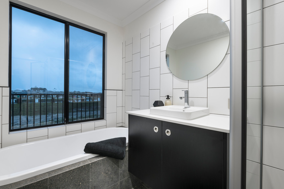 This is an example of a midcentury bathroom in Perth with black cabinets, white tile, ceramic tile, white walls, ceramic floors, grey floor, an open shower and a drop-in tub.