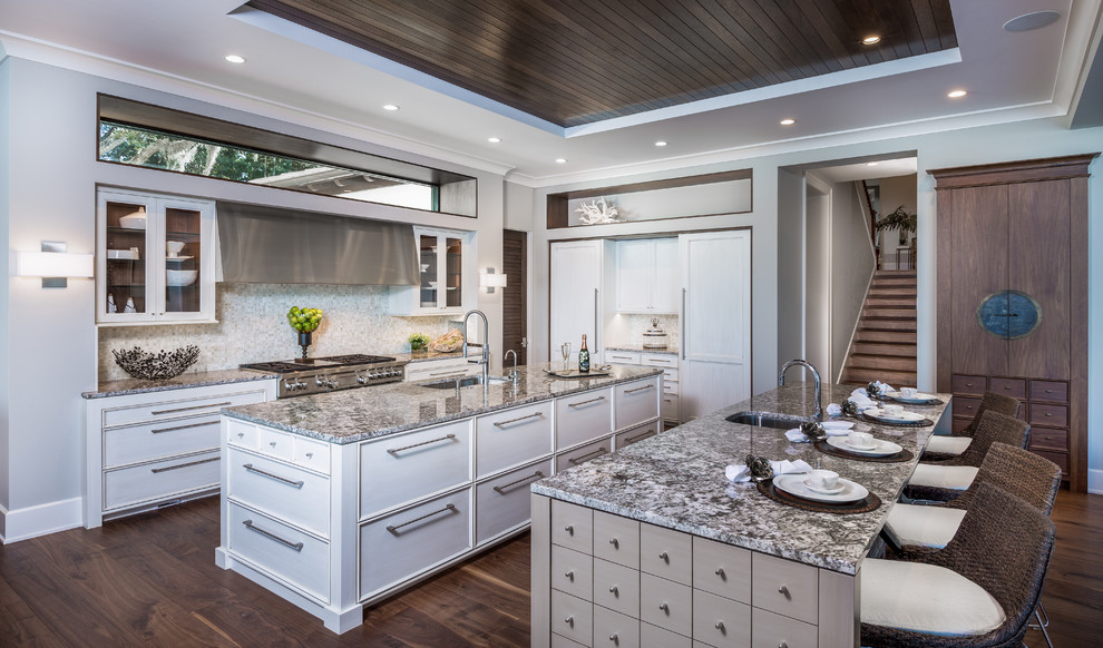 Kitchen - large transitional dark wood floor kitchen idea in Miami with an undermount sink, gray backsplash, stainless steel appliances and two islands