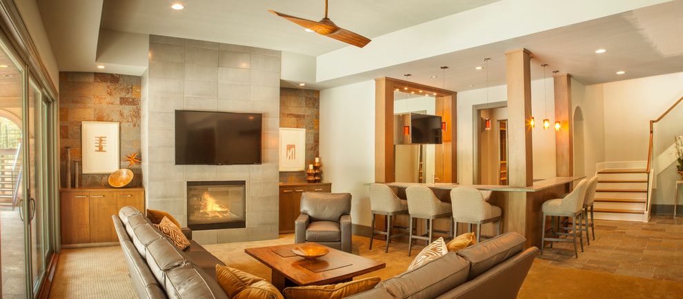 This is an example of a large contemporary walk-out basement in Charlotte with beige walls, carpet, a standard fireplace and a tile fireplace surround.