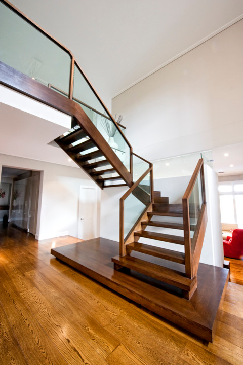 Design ideas for a large contemporary wood u-shaped staircase in Melbourne with open risers.