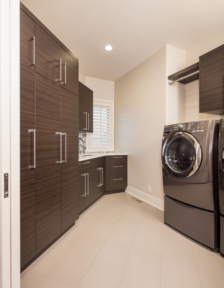 Dedicated laundry room - mid-sized transitional galley porcelain tile dedicated laundry room idea in Omaha with a side-by-side washer/dryer, a single-bowl sink, flat-panel cabinets, quartz countertops, gray walls and dark wood cabinets