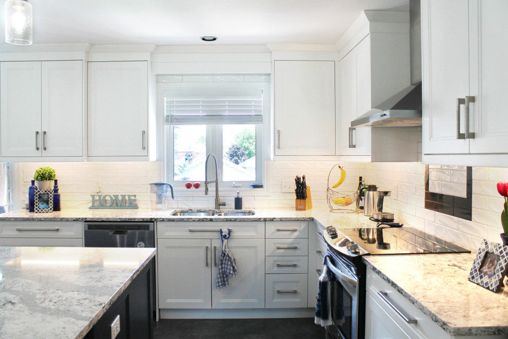 Example of a large transitional u-shaped eat-in kitchen design with shaker cabinets, white cabinets, quartz countertops, white backsplash, subway tile backsplash, stainless steel appliances, an island and gray countertops