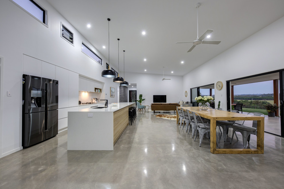 Inspiration for a large industrial open plan dining in Sunshine Coast with white walls, concrete floors, grey floor and no fireplace.