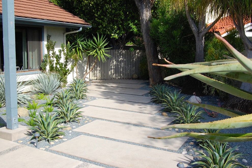 Design ideas for a mid-sized modern front yard partial sun formal garden in San Diego with a garden path and concrete pavers.