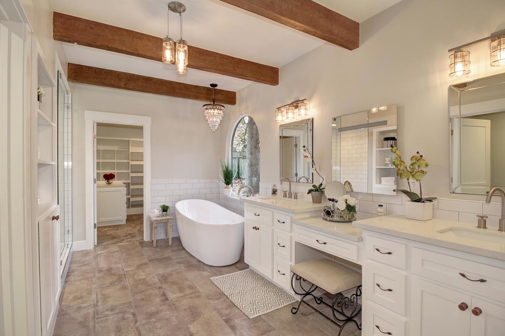 Mid-sized traditional master bathroom in Sacramento with shaker cabinets, white cabinets, a freestanding tub, white tile, grey walls, an undermount sink, engineered quartz benchtops, white benchtops, a double vanity and a built-in vanity.