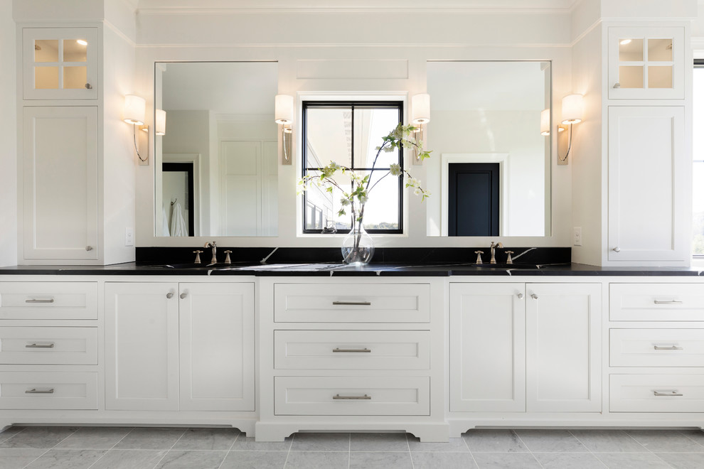 Design ideas for an expansive beach style master bathroom in Minneapolis with white cabinets, ceramic floors, engineered quartz benchtops, grey floor, black benchtops and shaker cabinets.
