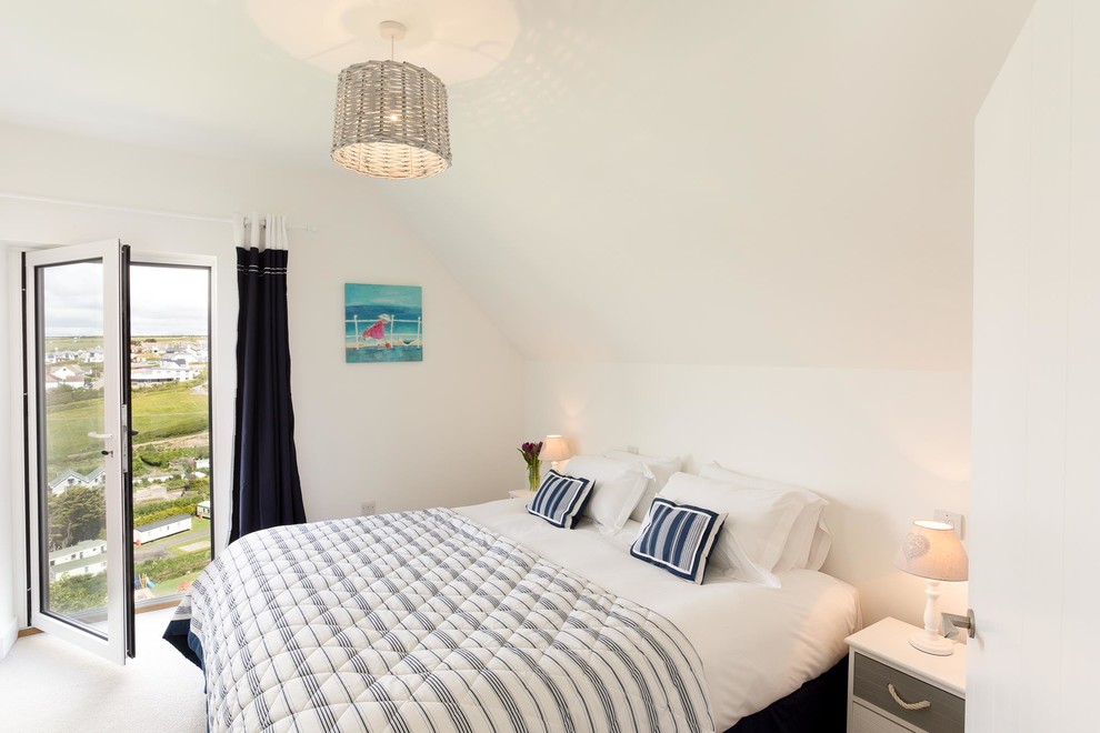 Design ideas for a beach style guest bedroom in Cornwall with white walls.