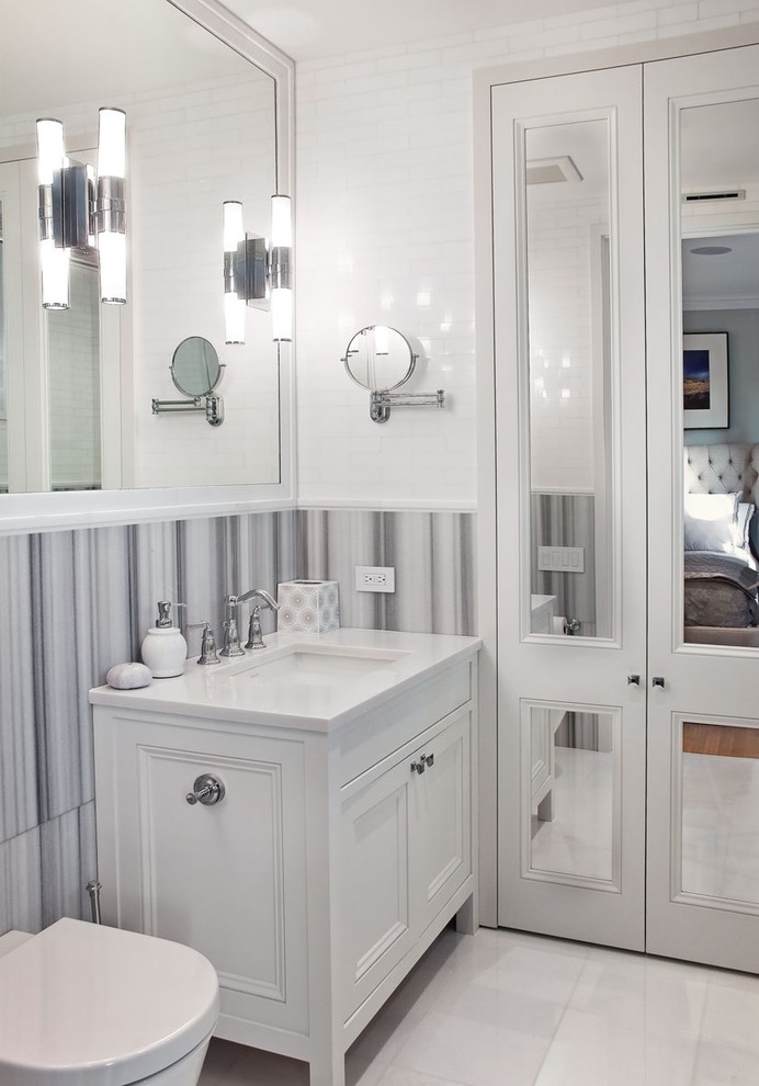 This is an example of a traditional bathroom in New York with recessed-panel cabinets and white cabinets.