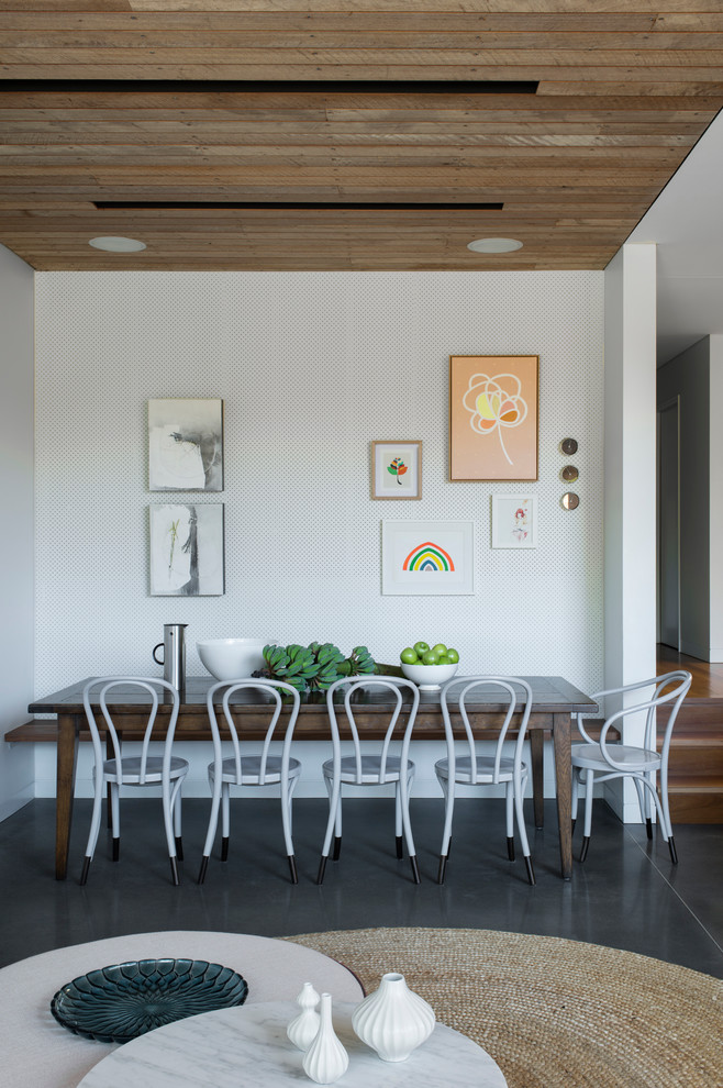 This is an example of a mid-sized contemporary kitchen/dining combo in Sydney with white walls, concrete floors and no fireplace.