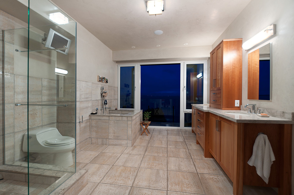 Photo of a mid-sized contemporary master bathroom in Vancouver with shaker cabinets, medium wood cabinets, an alcove tub, an alcove shower, a one-piece toilet, beige walls, ceramic floors and an undermount sink.