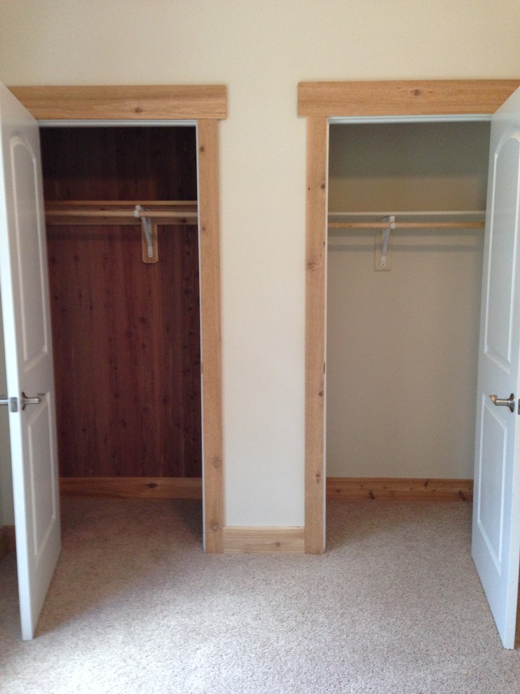 Design ideas for a country gender-neutral built-in wardrobe in Other with carpet.