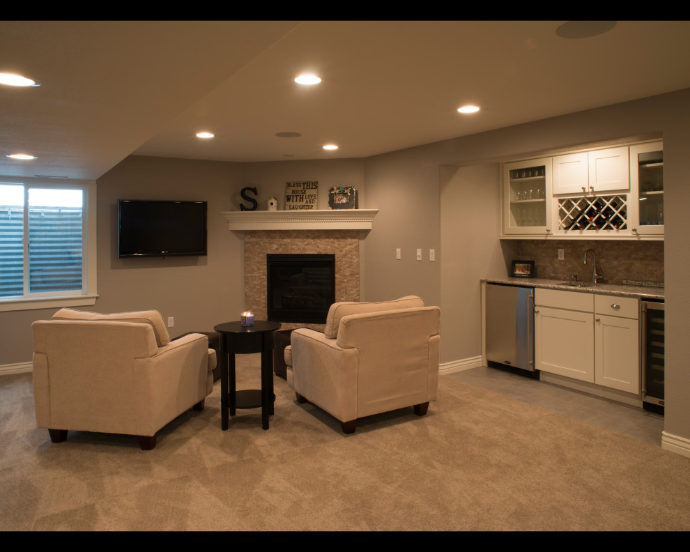 Photo of a medium sized traditional fully buried basement in Other with grey walls, carpet, a corner fireplace, a tiled fireplace surround and grey floors.