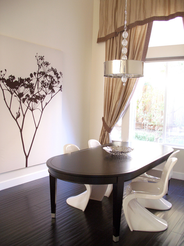 This is an example of a transitional dining room in San Francisco with white walls and dark hardwood floors.