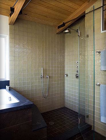 Photo of a large contemporary master bathroom in San Francisco with a drop-in sink, flat-panel cabinets, medium wood cabinets, engineered quartz benchtops, a japanese tub, a corner shower, a one-piece toilet, brown tile, ceramic tile, white walls and ceramic floors.