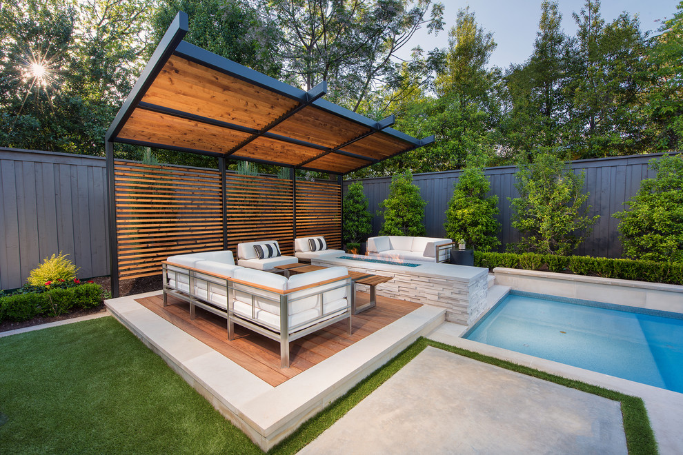 Design ideas for a transitional backyard deck in Dallas with a fire feature and a pergola.