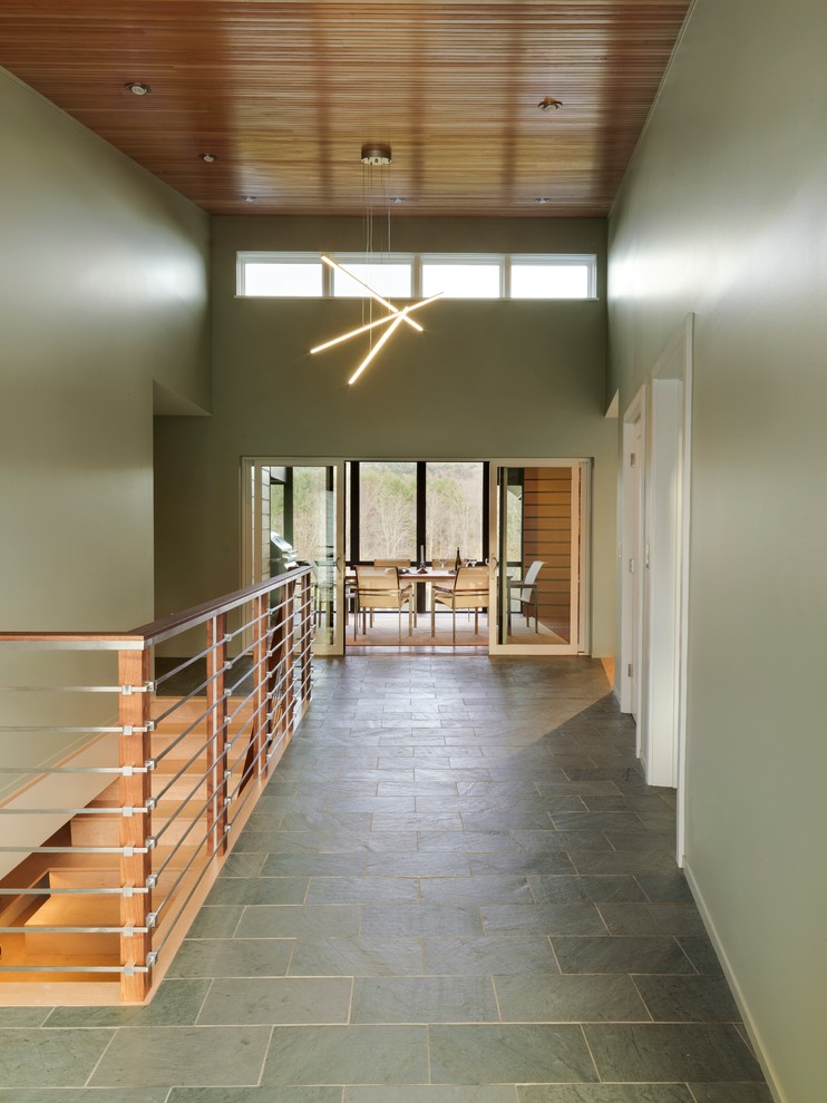 Design ideas for a large midcentury hallway in Burlington with green walls and slate floors.