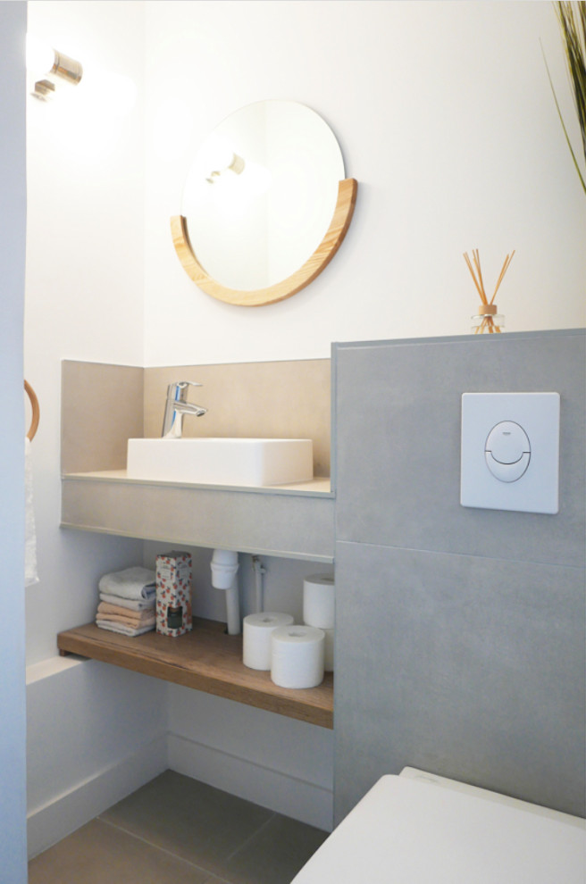 This is an example of a medium sized contemporary cloakroom in Marseille with open cabinets, medium wood cabinets, a wall mounted toilet, grey tiles, terracotta tiles, white walls, concrete flooring, a vessel sink, concrete worktops, grey floors, grey worktops and a floating vanity unit.
