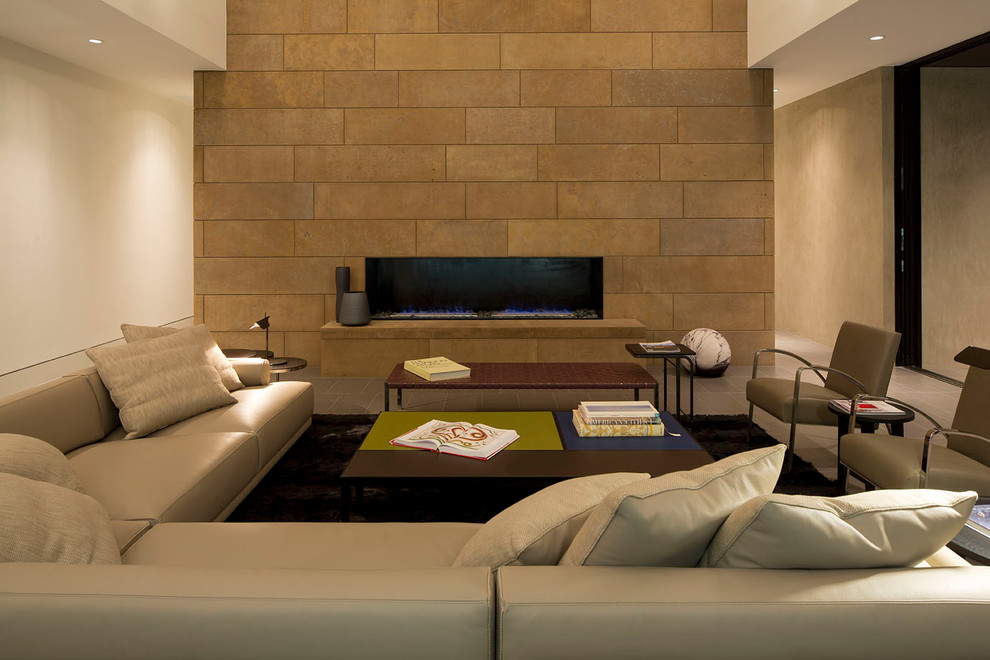 Contemporary living room in Austin with concrete floors, a tile fireplace surround and white walls.