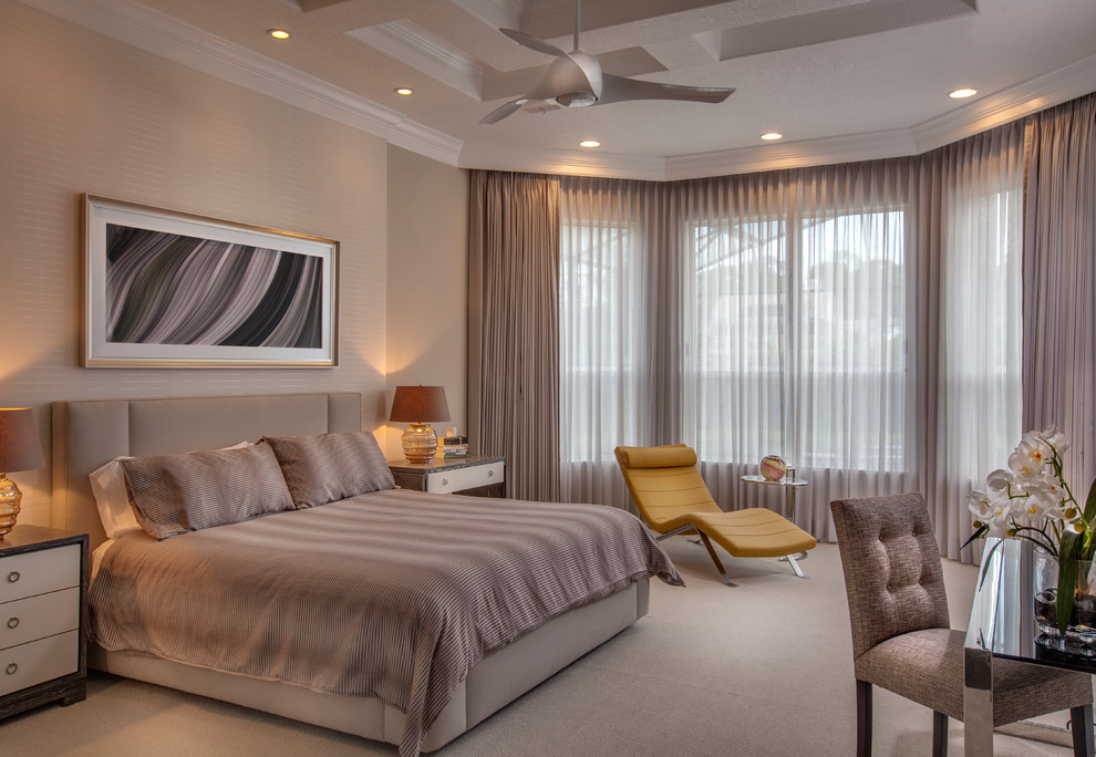 Large transitional master bedroom in Orlando with beige walls, carpet and beige floor.