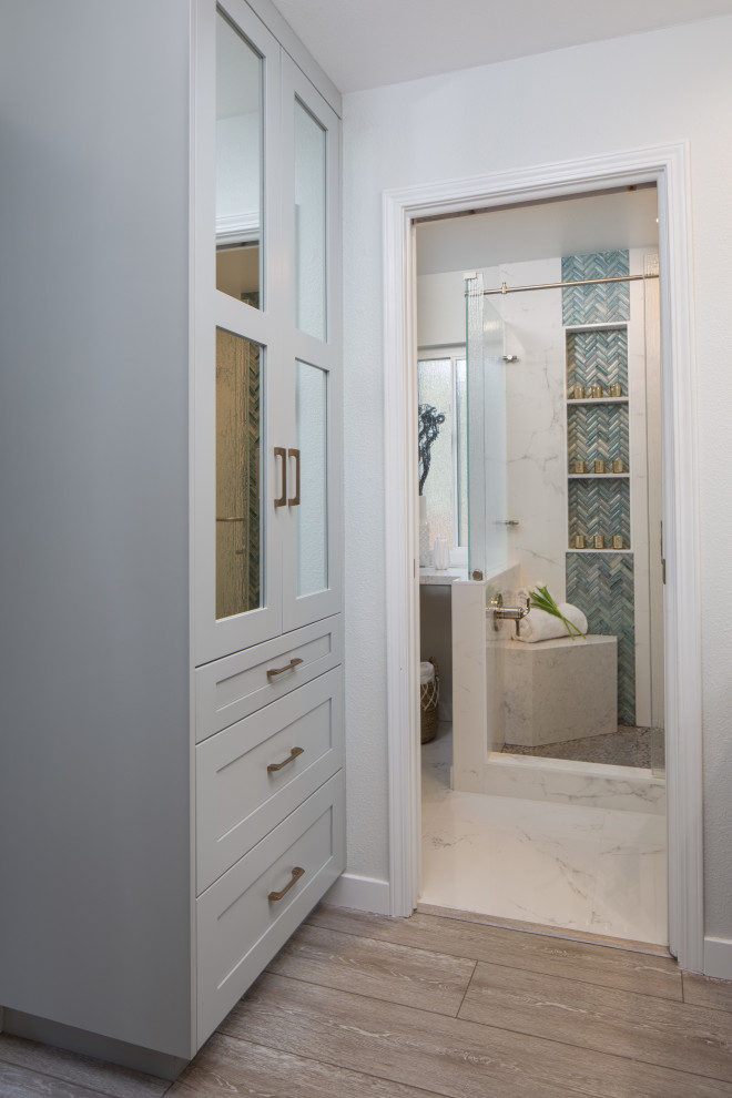 Large master wet room bathroom in San Diego with flat-panel cabinets, dark wood cabinets, a one-piece toilet, blue tile, white walls, a vessel sink, engineered quartz benchtops, green floor, a hinged shower door and white benchtops.