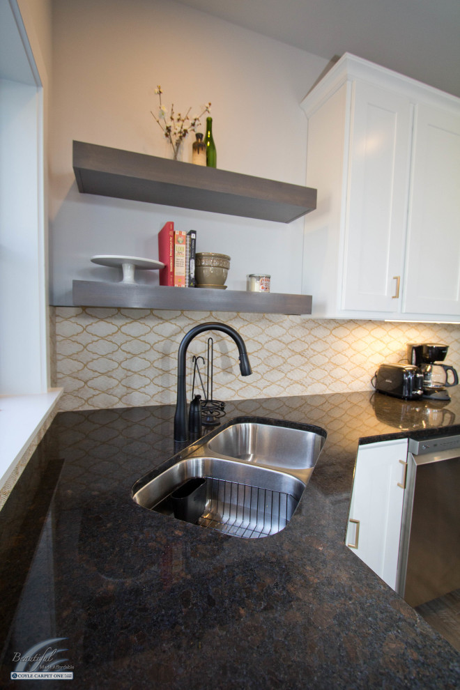 Kitchen - large transitional medium tone wood floor and brown floor kitchen idea with an undermount sink, recessed-panel cabinets, white cabinets, granite countertops, yellow backsplash, stainless steel appliances, black countertops and mosaic tile backsplash