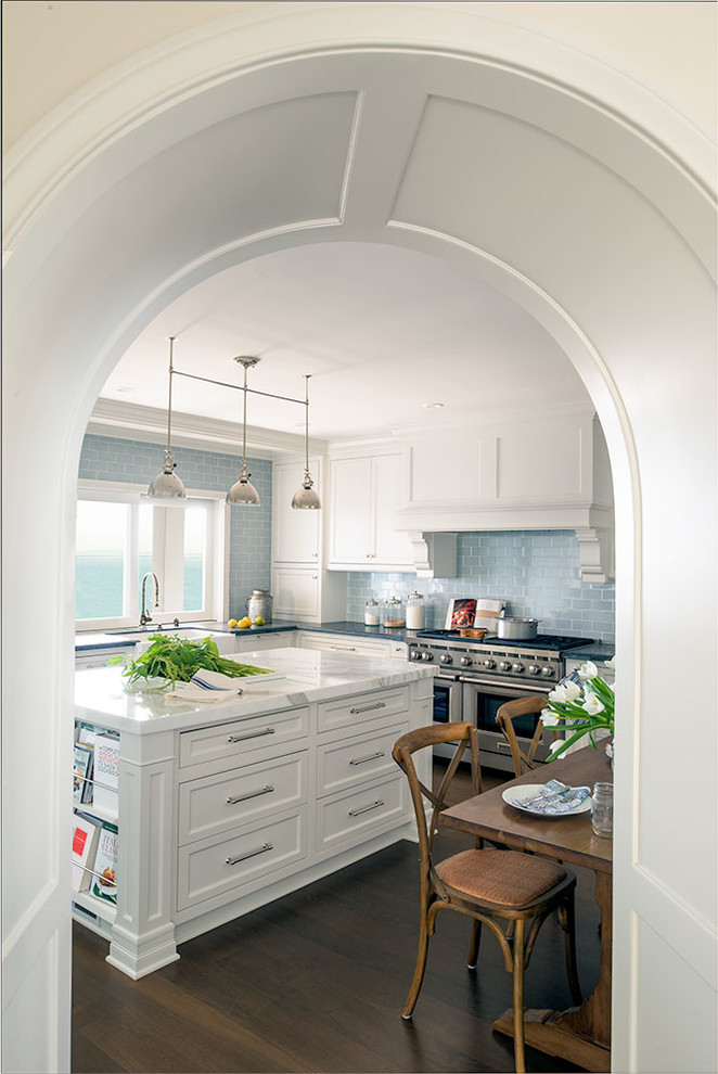 Inspiration for a large beach style u-shaped eat-in kitchen in Los Angeles with an undermount sink, white cabinets, soapstone benchtops, blue splashback, ceramic splashback, stainless steel appliances, dark hardwood floors and with island.