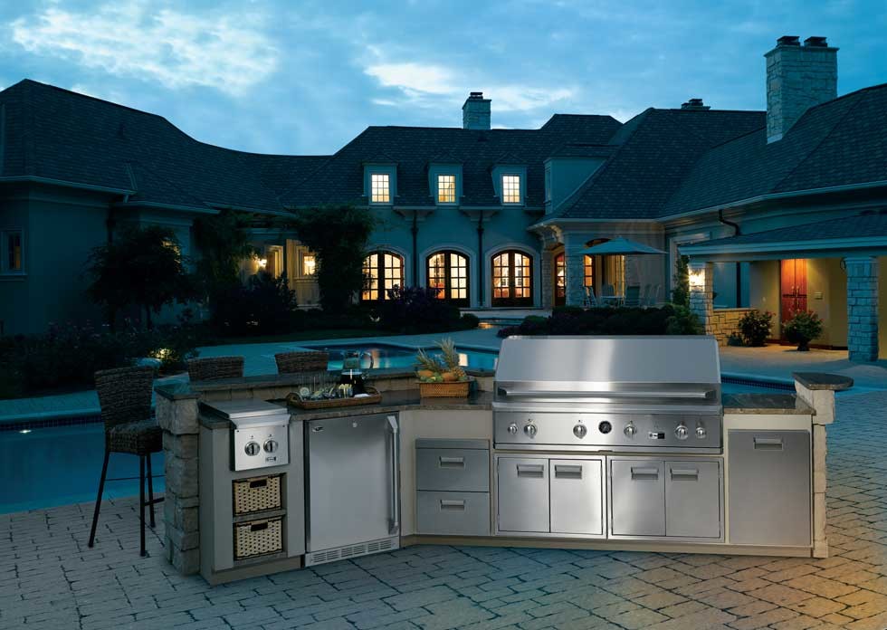 Inspiration for a large traditional backyard patio in Other with an outdoor kitchen, brick pavers and no cover.