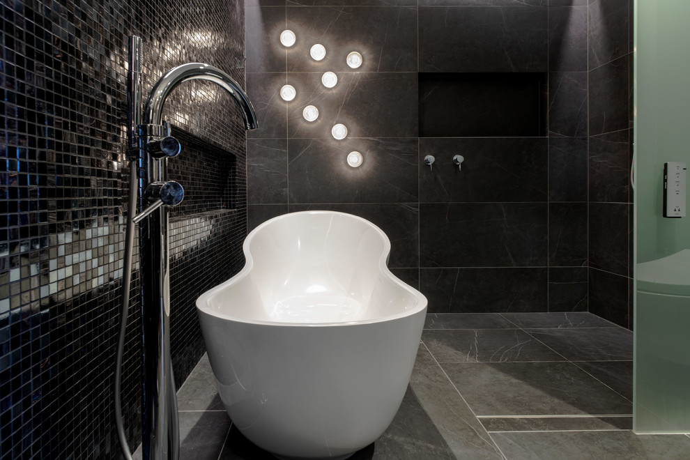 Inspiration for a contemporary bathroom in Sydney with a freestanding tub, a curbless shower, black tile, gray tile, mosaic tile, black walls, grey floor and an open shower.