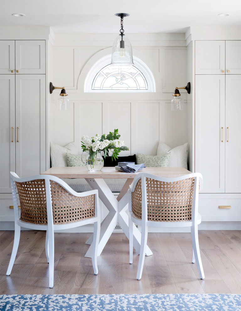 Inspiration for a large beach style dining room in Other with white walls, light hardwood floors and beige floor.