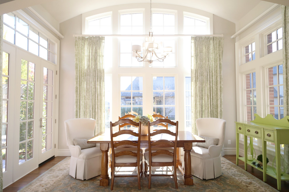 Mid-sized traditional separate dining room in Other with medium hardwood floors, white walls and no fireplace.