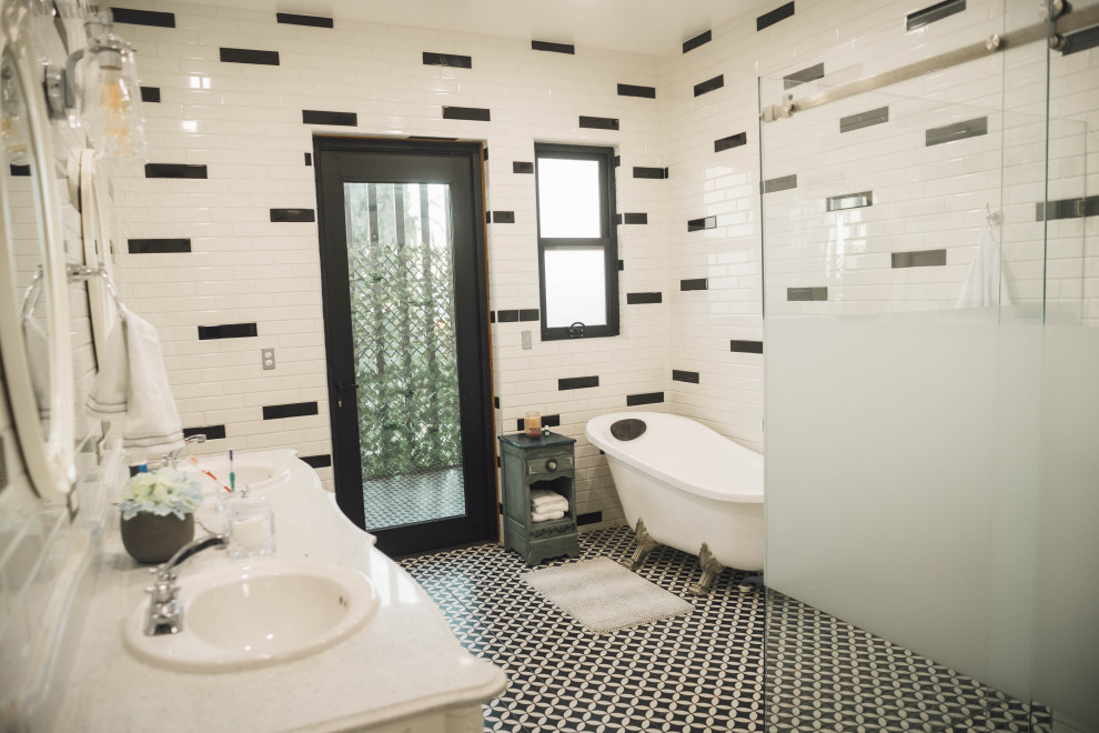 This is an example of a large eclectic master bathroom in Other with furniture-like cabinets, white cabinets, a claw-foot tub, a corner shower, a two-piece toilet, black and white tile, subway tile, white walls, mosaic tile floors, a drop-in sink, quartzite benchtops, black floor, a hinged shower door, white benchtops, an enclosed toilet, a double vanity and a freestanding vanity.