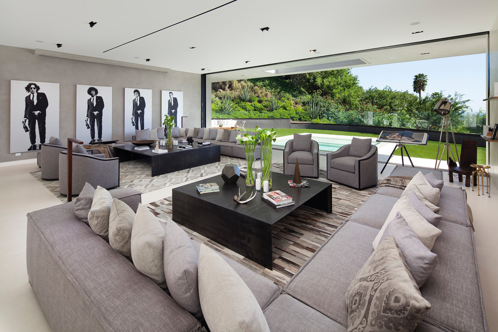 Photo of an expansive contemporary formal open concept living room in Los Angeles with grey walls, concrete floors, no fireplace, no tv and white floor.