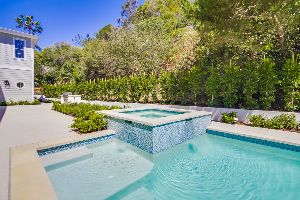 Inspiration for an expansive arts and crafts backyard rectangular lap pool in San Diego with a hot tub and concrete pavers.