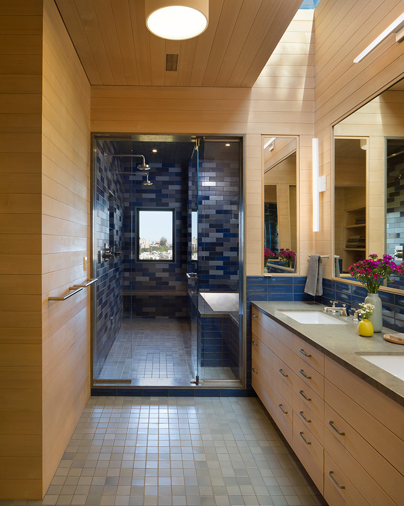Photo of a large contemporary master wet room bathroom in San Francisco with flat-panel cabinets, light wood cabinets, an undermount tub, blue tile, ceramic tile, brown walls, ceramic floors, an undermount sink, blue floor and a hinged shower door.