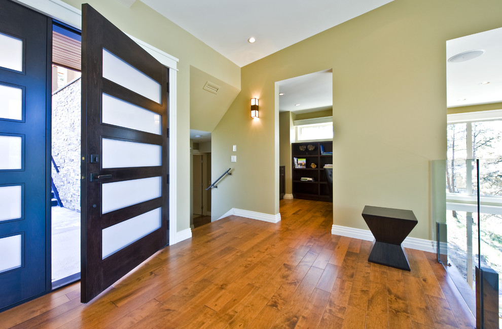 Inspiration for a contemporary entryway in Vancouver with beige walls and a dark wood front door.