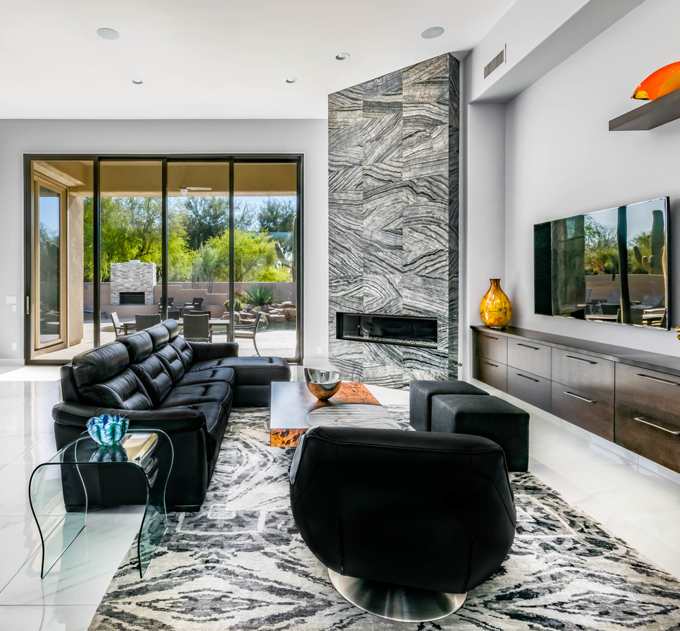 Inspiration for a large contemporary open concept family room in Phoenix with grey walls, marble floors, a tile fireplace surround, a wall-mounted tv and a ribbon fireplace.