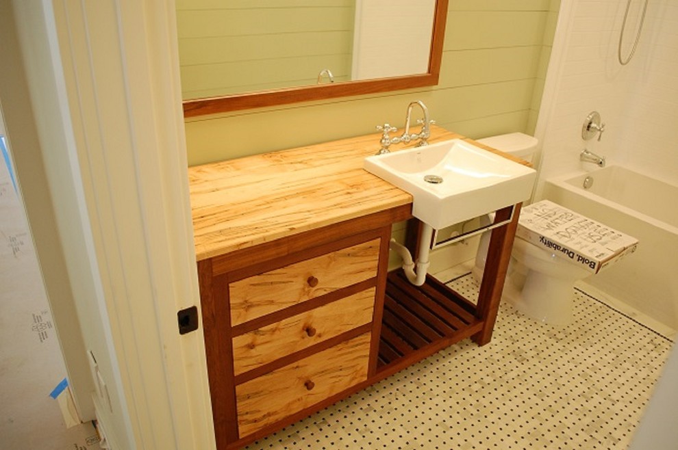 Design ideas for a mid-sized country master bathroom in Orlando with medium wood cabinets, white tile, wood benchtops, a shower/bathtub combo, a one-piece toilet, green walls and marble floors.