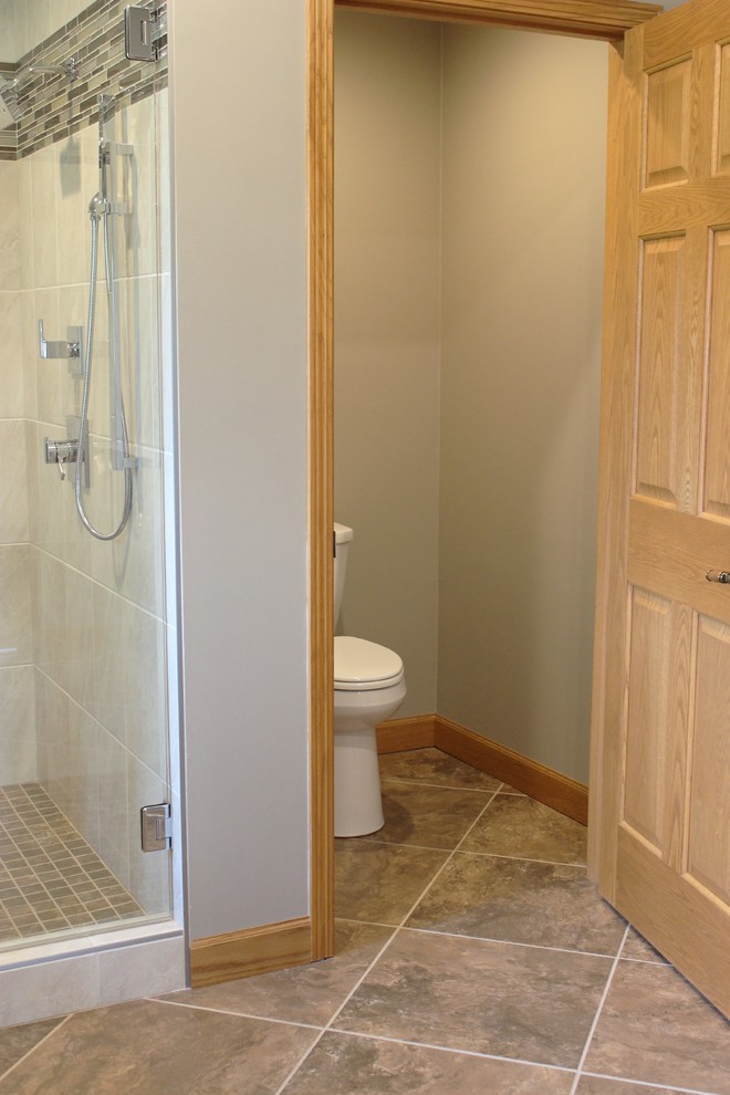Example of a large classic master beige tile and ceramic tile ceramic tile bathroom design in Chicago with raised-panel cabinets, dark wood cabinets, beige walls, a vessel sink and quartz countertops