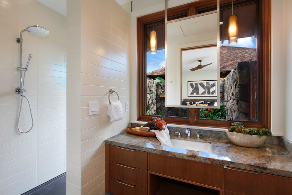 Inspiration for a mid-sized tropical bathroom in Hawaii with flat-panel cabinets, medium wood cabinets, white tile, porcelain tile, white walls, an undermount sink, granite benchtops, grey floor, multi-coloured benchtops, an open shower and an open shower.