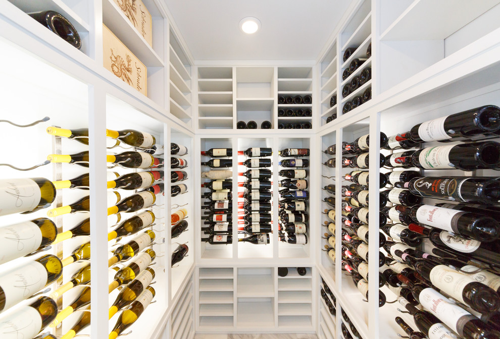 Mid-sized contemporary wine cellar in New York with marble floors and storage racks.