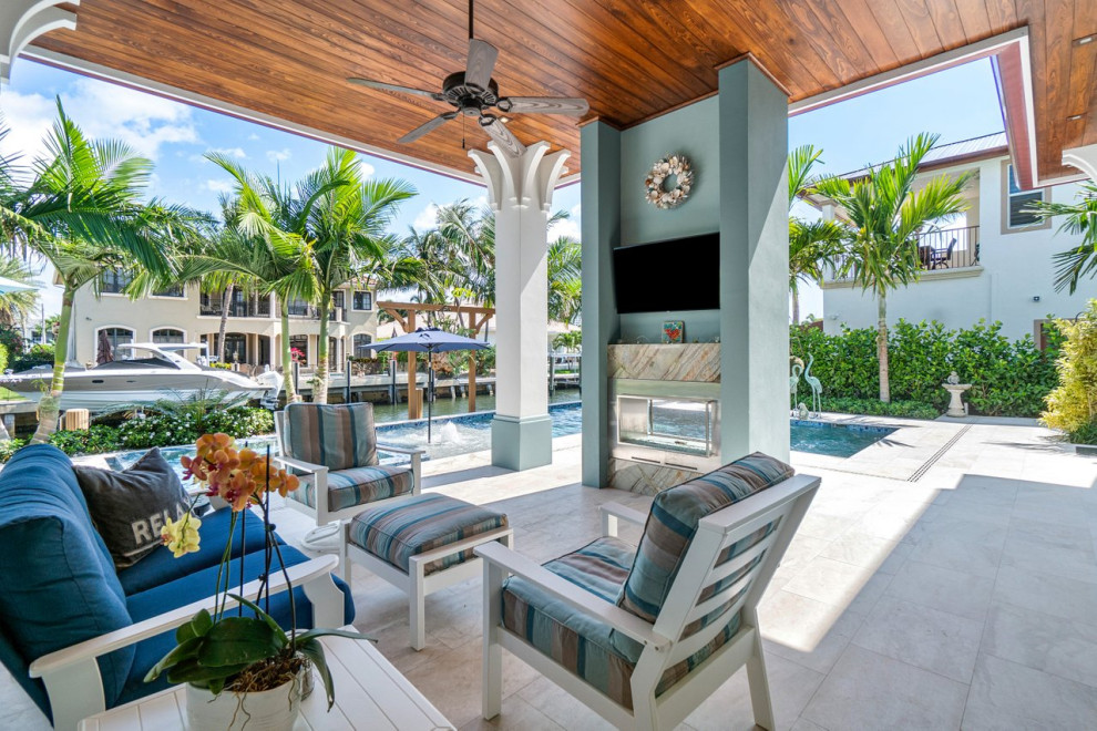 Hot tub - large coastal backyard tile and l-shaped hot tub idea in Miami
