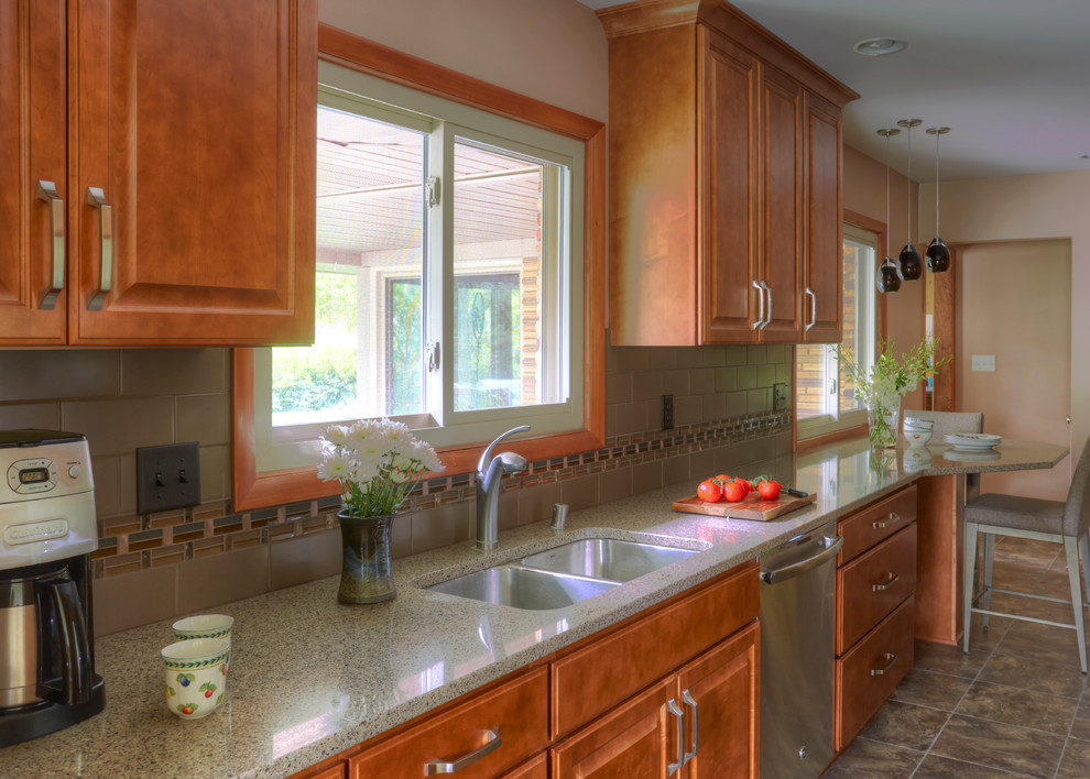 Inspiration for a small transitional galley vinyl floor enclosed kitchen remodel in Milwaukee with an undermount sink, raised-panel cabinets, medium tone wood cabinets, quartz countertops, multicolored backsplash, porcelain backsplash, stainless steel appliances and no island