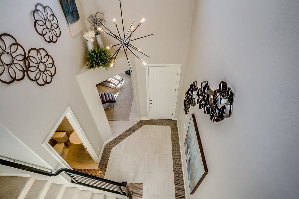 Design ideas for a mid-sized contemporary foyer in Phoenix with ceramic floors and beige floor.
