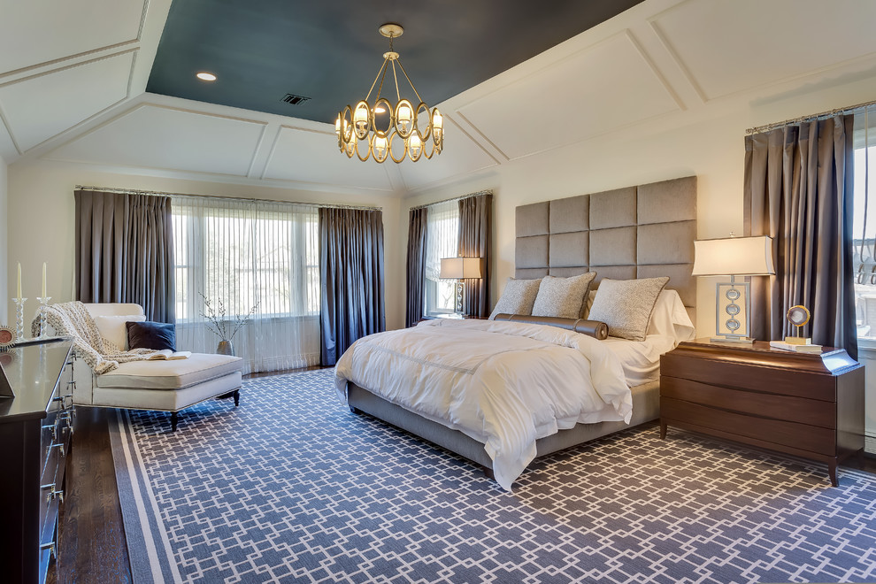 Photo of a large transitional master bedroom in New York with white walls, dark hardwood floors, no fireplace and brown floor.