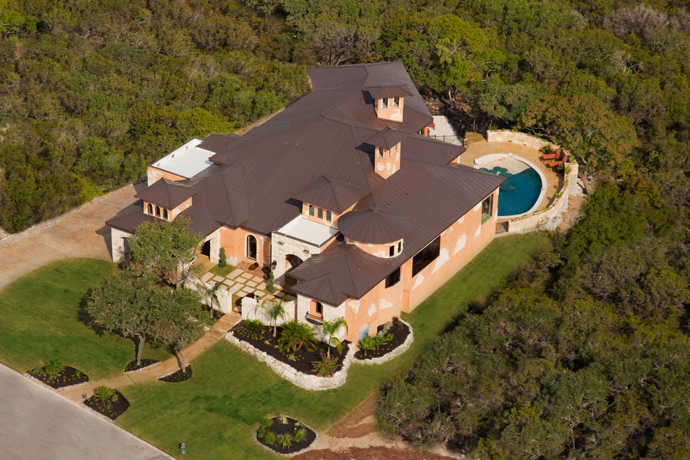 Inspiration for a mediterranean two-story stucco beige home design remodel in Dallas