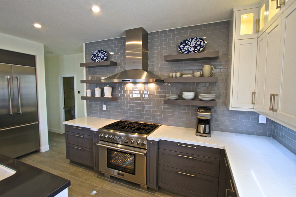 Inspiration for a transitional porcelain tile kitchen remodel in Orange County with glass tile backsplash and an island
