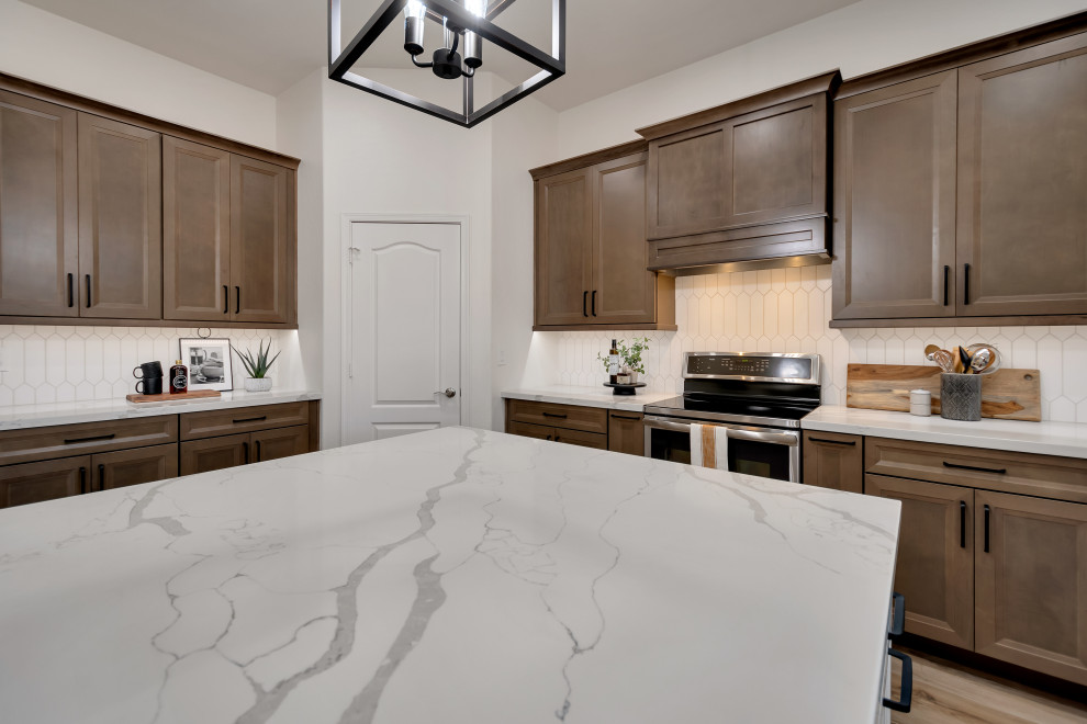 Mid-sized transitional u-shaped ceramic tile and brown floor eat-in kitchen photo in Phoenix with beaded inset cabinets, brown cabinets, quartzite countertops, white backsplash, ceramic backsplash, an island and white countertops