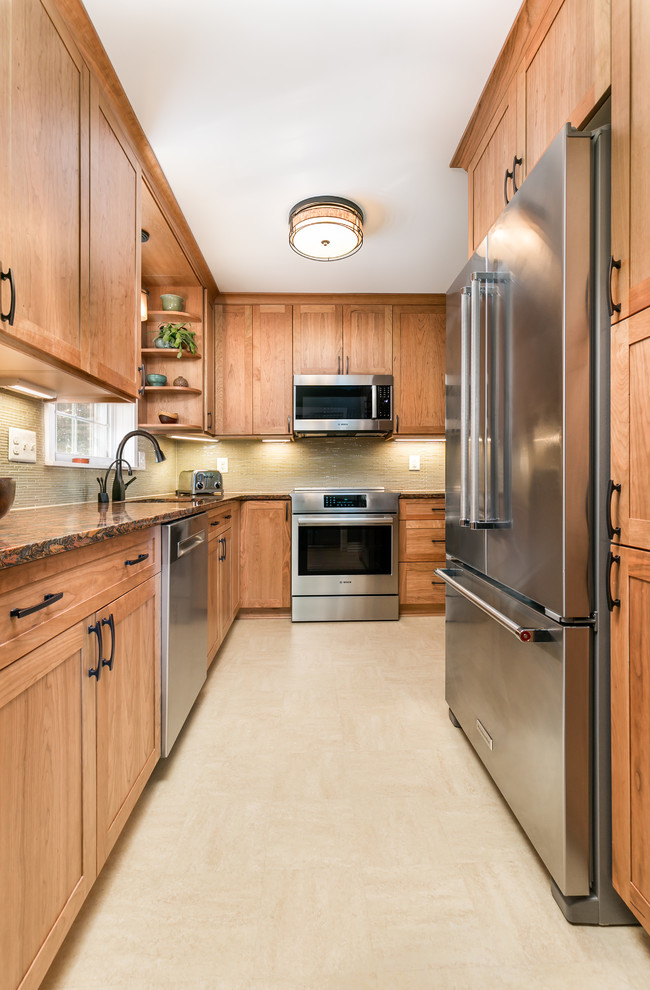 Photo of a small transitional l-shaped separate kitchen in DC Metro with an undermount sink, shaker cabinets, medium wood cabinets, quartz benchtops, yellow splashback, glass sheet splashback, stainless steel appliances, linoleum floors and yellow floor.